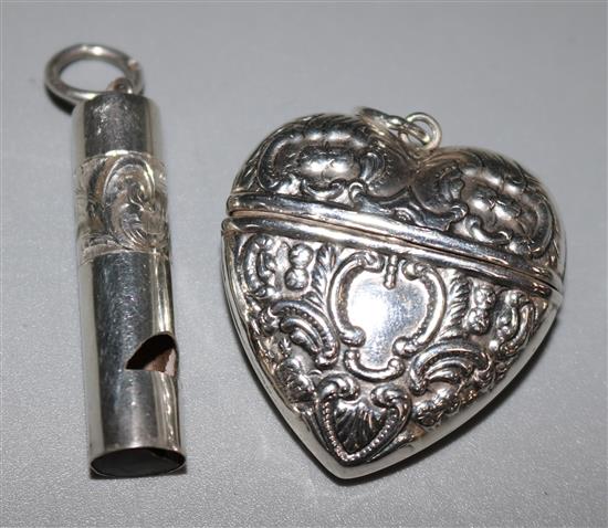 A late Victorian silver whistle and a continental repousse silver heart shaped pill box.